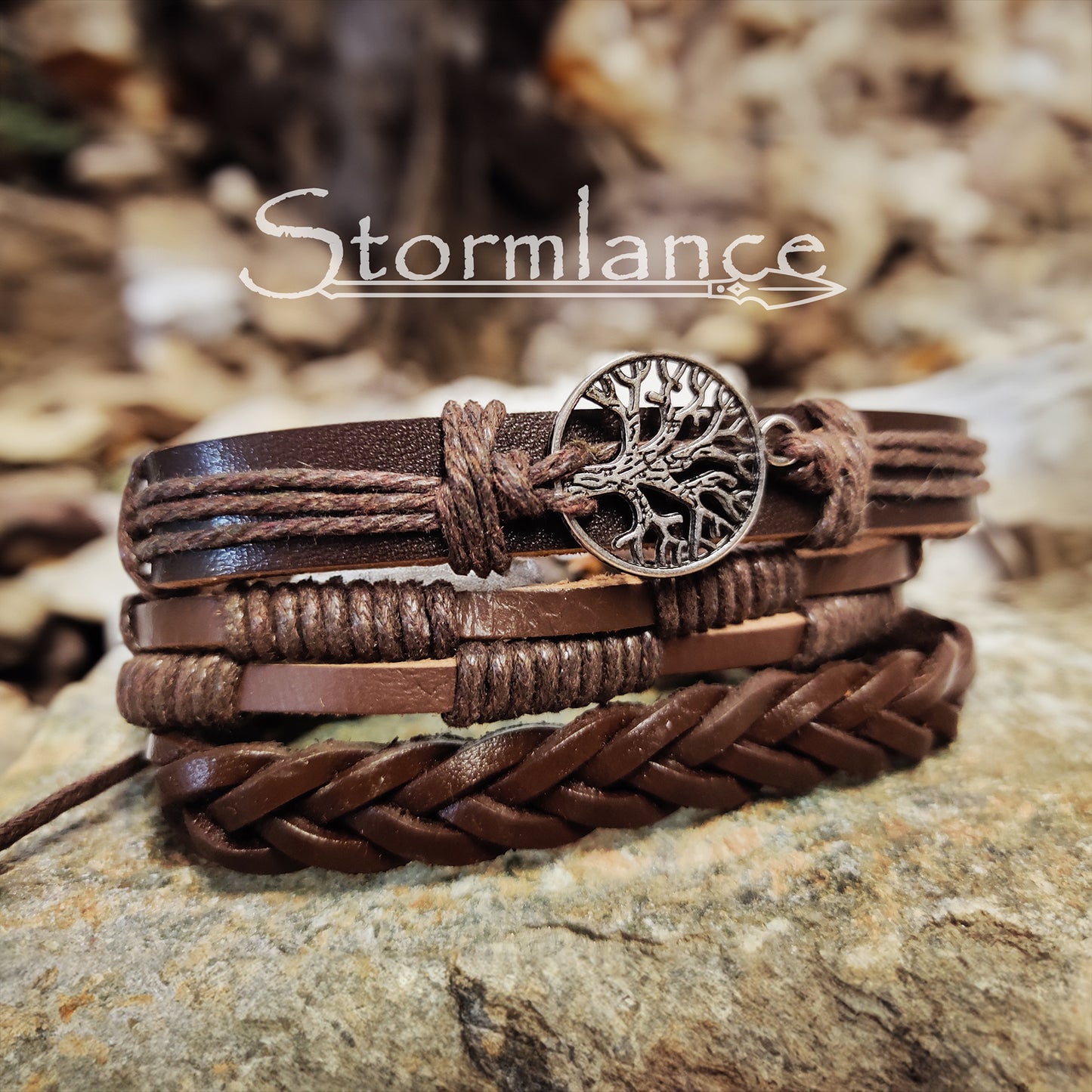 brown PU leather bracelet with yggdrasil laying on a granite stone slab