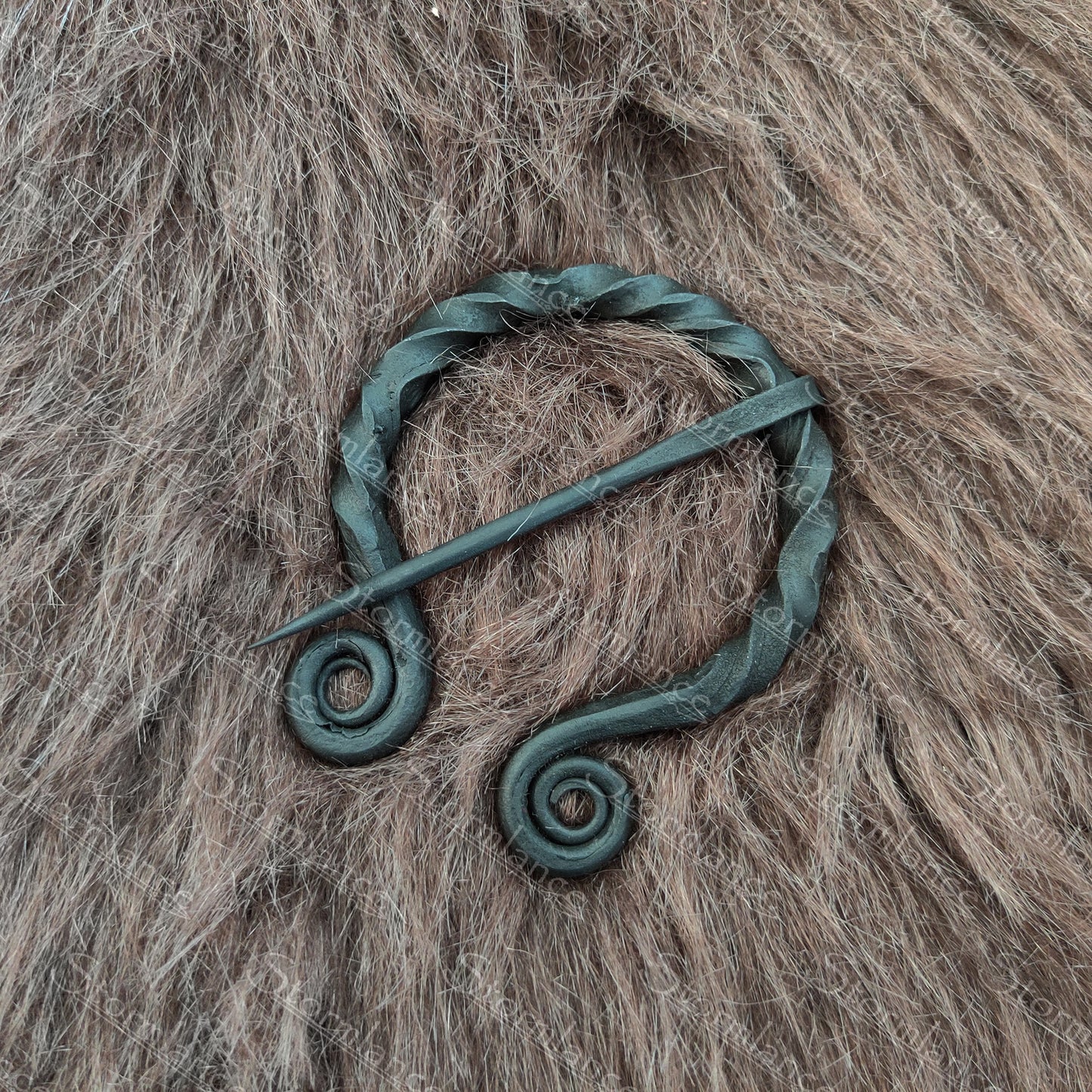 hand forged iron fibula with spiral twisted design