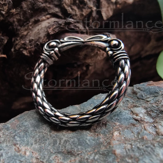 huginn and muninn ring made of stainless steel, laying on a granite stone slab