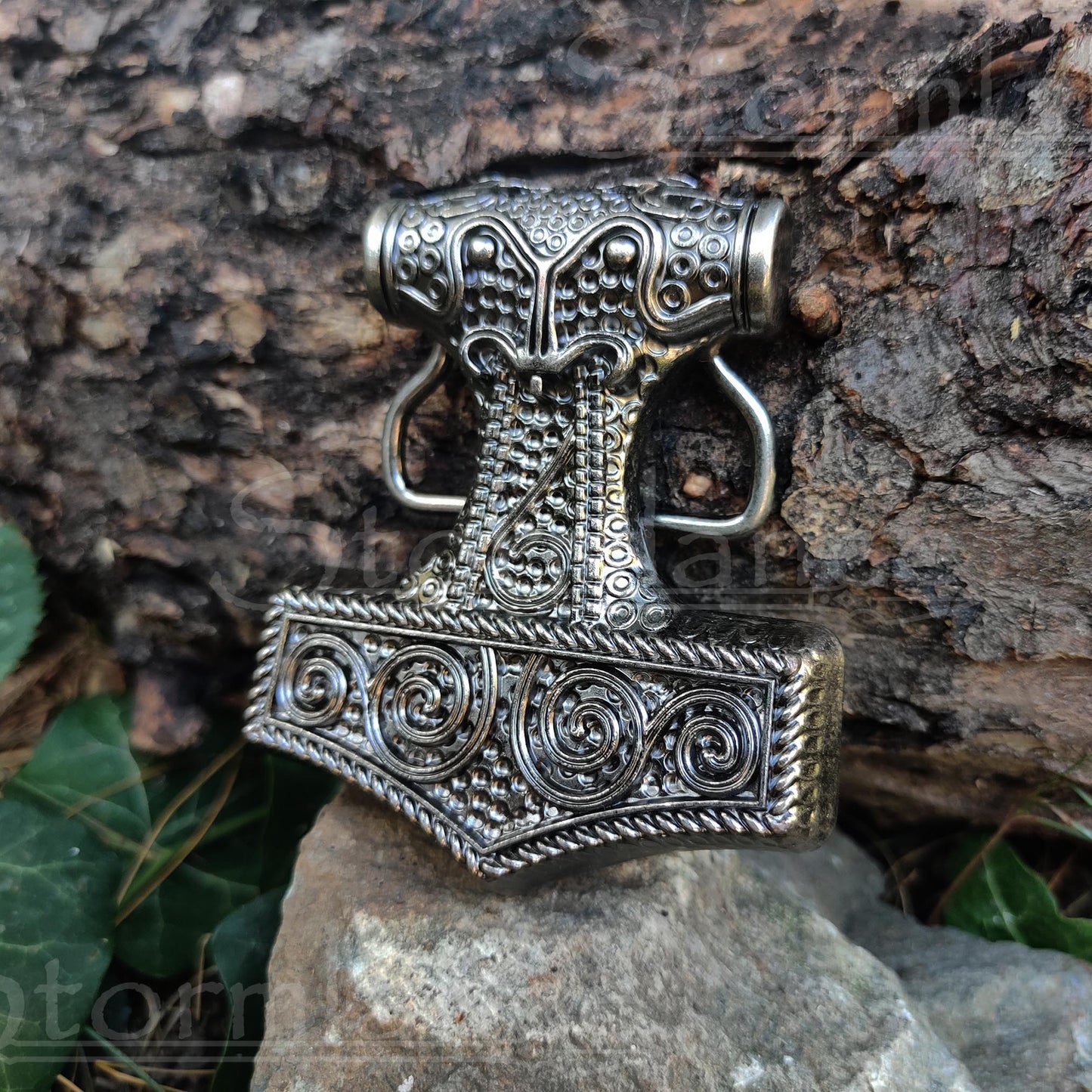 Viking Mjolnir Belt Buckle made of stainless steel, laying in a forest