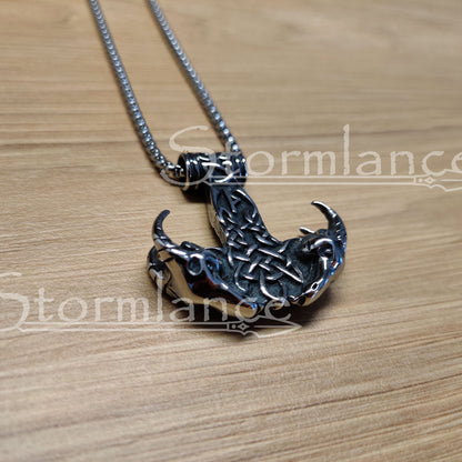 Mjolnir with Thor's goats pendant made of stainless steel, laying on a wooden desk