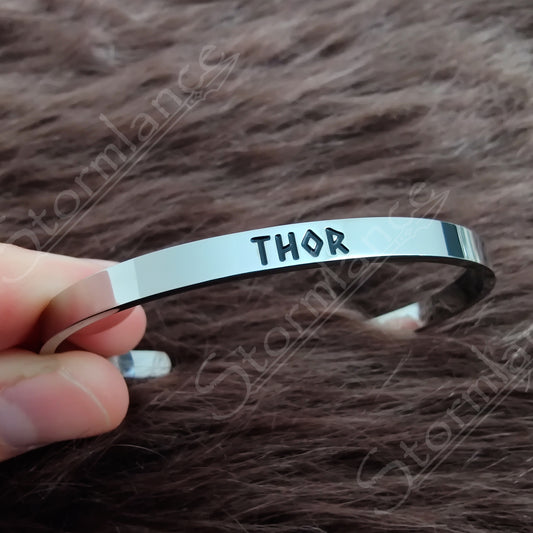 Modern Simple Design Thor Arm Ring (Cuff) placed on a wooden desk