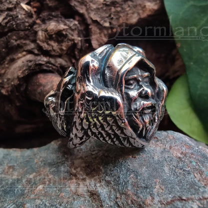 odin head with ravens ring made of stainless steel, laying on a granite stone slab