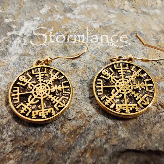 Vegvisir Earrings Gold in Color made of stainless steel laying on a stone slab