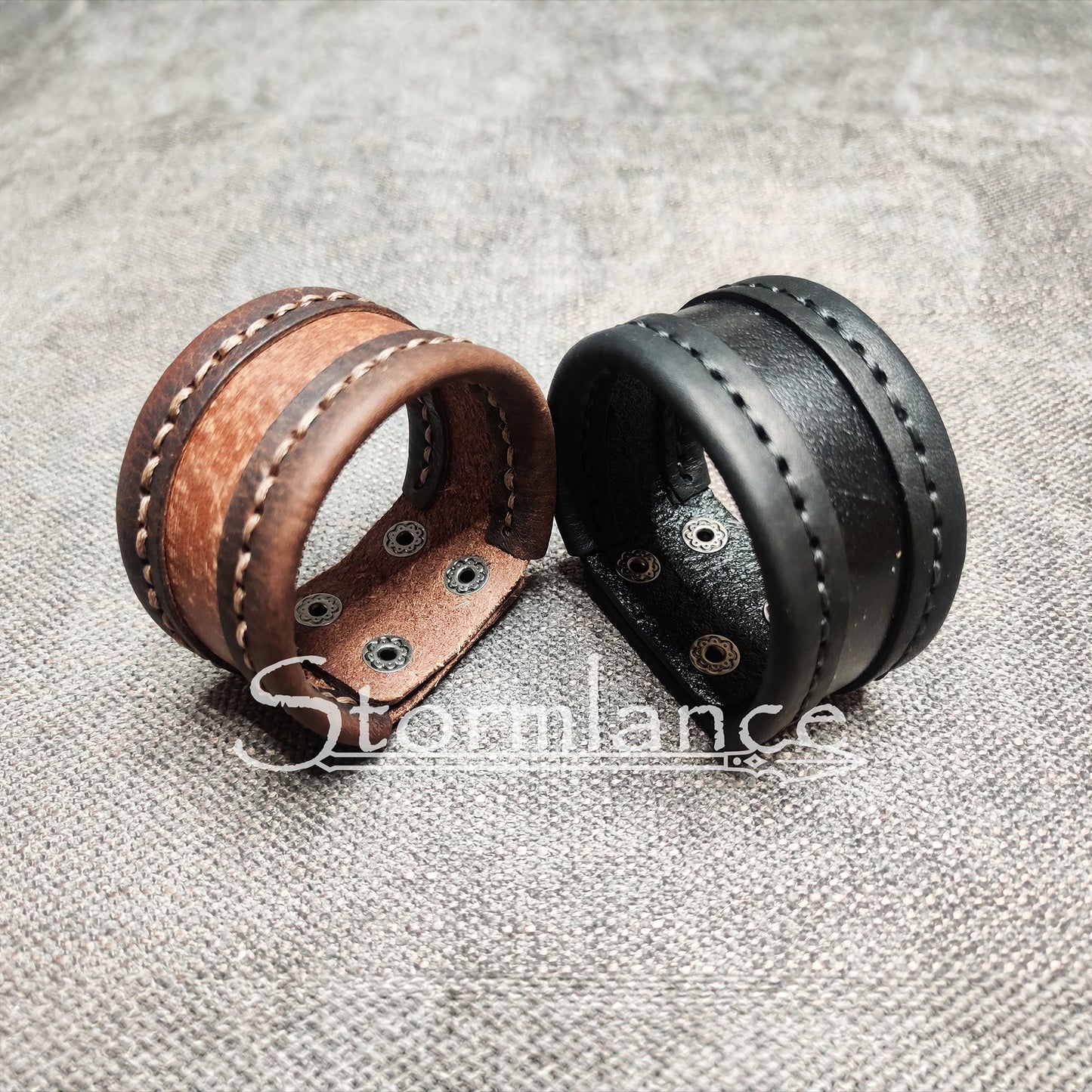 brown and black genuine leather bracelets laying on a cotton fabric