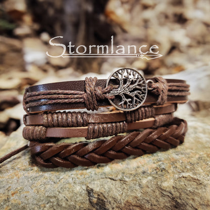 brown PU leather bracelet with yggdrasil  laying on a granite stone slab