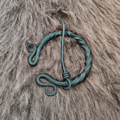 hand forged iron fibula with aristocratic twisting style