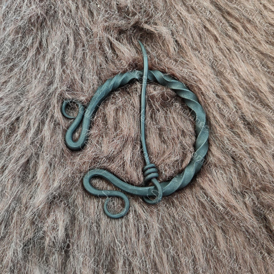 hand forged iron fibula with aristocratic twisting style