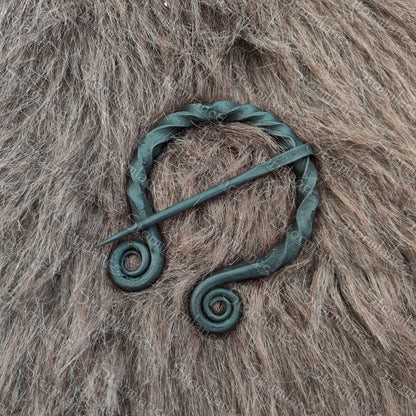 hand forged iron fibula with spiral twisted design