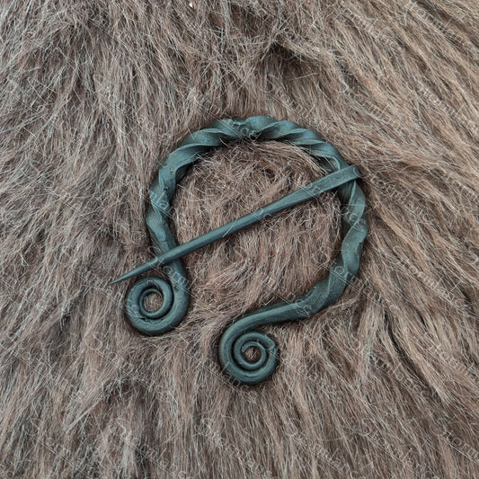 hand forged iron fibula with spiral twisted design