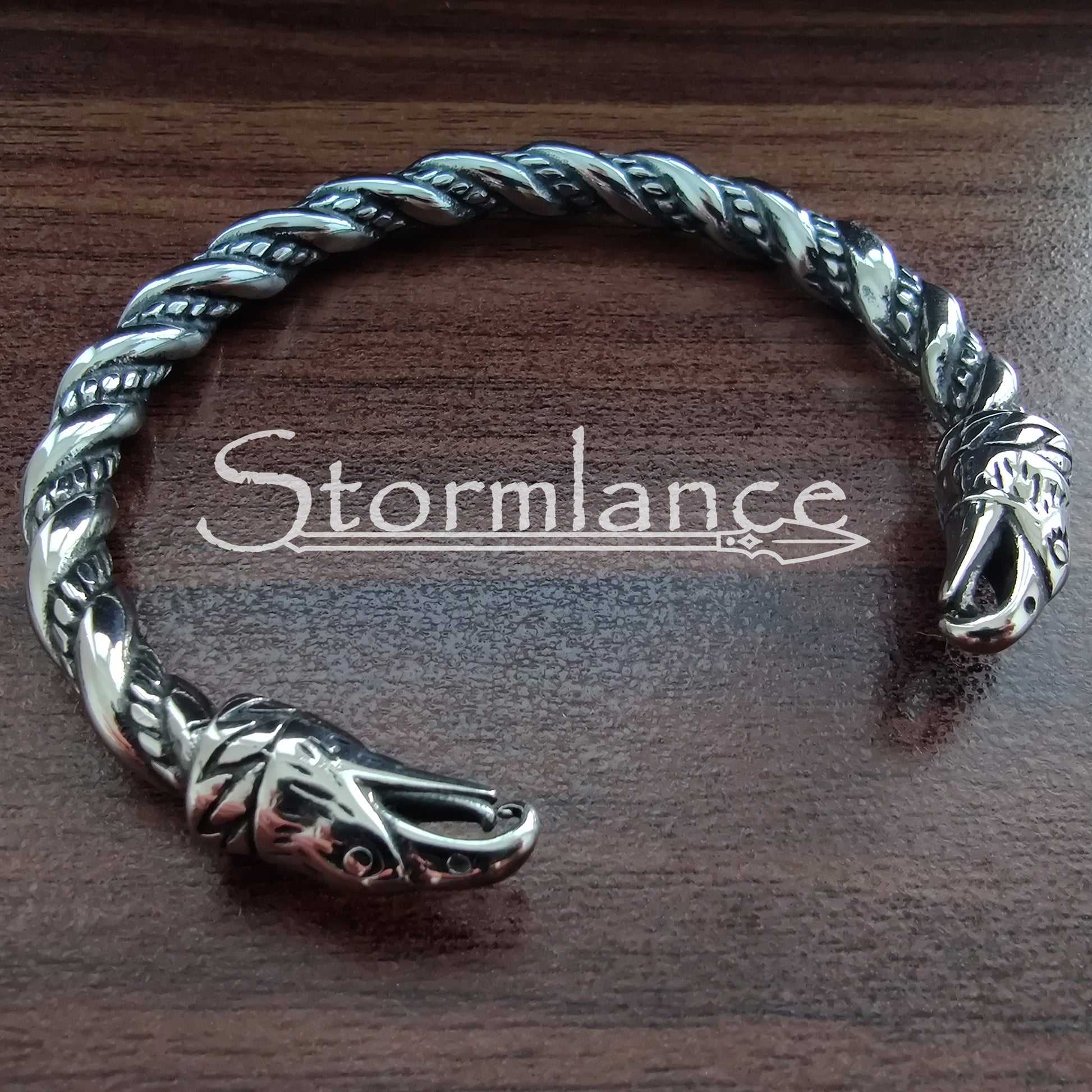 Odin's Ravens Bracelet made of Stainless Steel on a wooden background