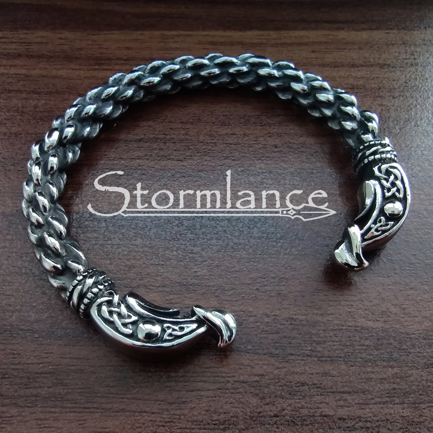 Ragnar Lothbrok Arm Ring made of Stainless Steel on a wooden background